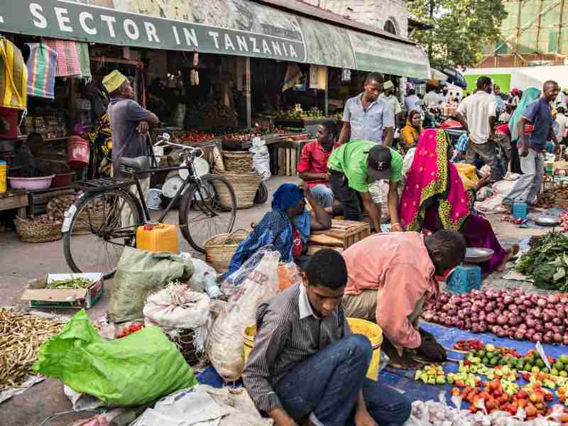 STONE TOWN, TANZANIA - January 2018 Overcrowded local fruit and vegetable market with lots of sellers and buyers in Stone town, Zanzibar, Tanzania